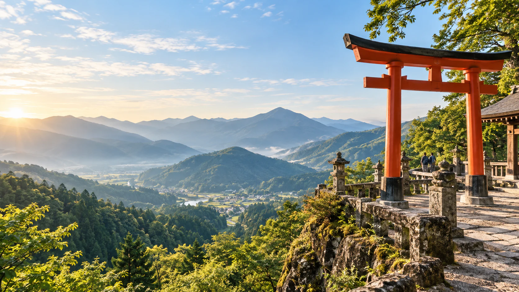 A vermilion torii gate overlooking a sunlit valley and Japanese mountains