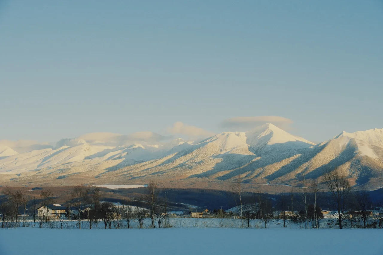 Sunlit snow-covered mountains near Furano in Hokkaido, Japan